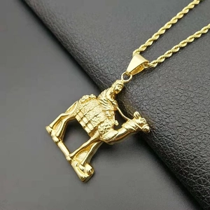 Gold plated stainless steel camel pendant with twist chain on black leather background