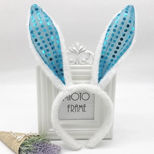 Detail of white plush headband with blue sequin bunny ears on a decorative photo frame