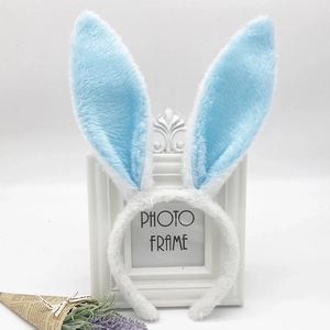Detailed view of plush blue and white sequin rabbit ear headband on elegant display