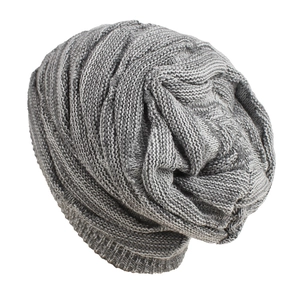Close-up of grey slouchy beanie showing thick vertical knit texture and ribbed cuff