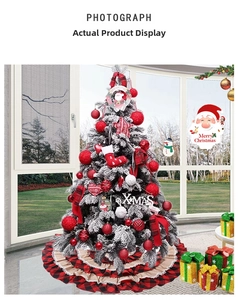 Detail of red and black plaid tiered Christmas tree skirt with festive ornaments and snow effect