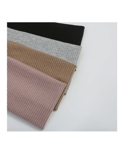 Detailed close-up of knitted ribbed sports headbands in black, grey, khaki and pink