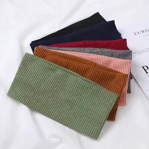 Variety of ribbed knit headbands in multiple colors on a clean white fabric background