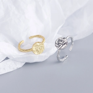 Detail of irregular hammer texture on adjustable silver and gold metal rings