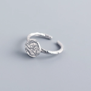 Macro detail of S925 silver ring featuring irregular hammered foil texture and round surface