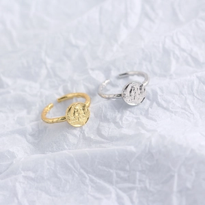 Detailed view of gold and silver S925 sterling silver rings with hammered texture surface