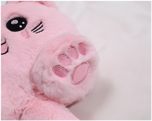 Detailed close-up of pink plush kitten bag showing soft fur texture and embroidered cat paw