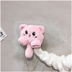 Detailed close-up of a pink plush cat bag with a golden chain strap and cute embroidery