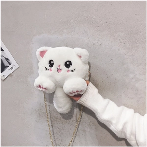 Detail of cute white plush cat crossbody bag featuring a golden metal chain strap