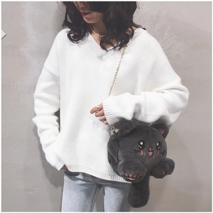 Detail of cute dark gray plush cat bag with gold chain strap worn by a model
