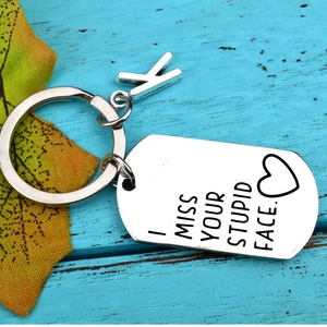 Stainless steel keychain with 'I MISS YOUR STUPID FACE' engraving and letter K charm