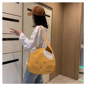 Detail of cute yellow cat canvas bag featuring adjustable strap and patchwork design