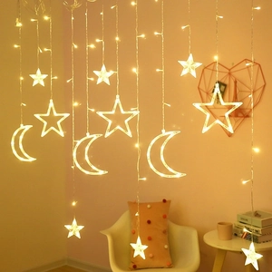 Close-up of warm yellow LED star and moon shaped hanging lights for window decoration