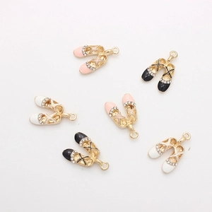 Detail view of ballet shoe alloy charms with rhinestones in pink, black, and white colors