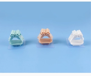 Detailed view of plastic mop holders in green, apricot, and white with roller design