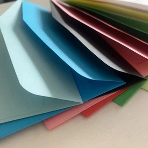 Macro detail of colorful kraft paper envelopes with heart-shaped clasps in various colors