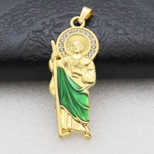 Macro view of St. Jude religious pendant with green enamel and white crystals