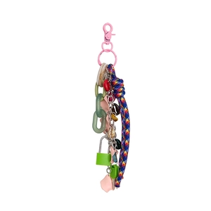 Detail of DIY mini lock bag charm with pink and green resin, metal, and woven rope
