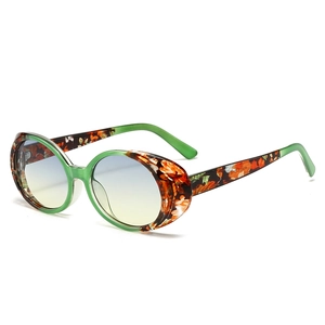 Retro oval sunglasses with floral green frames and blue-yellow gradient lenses
