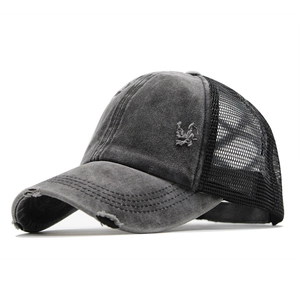 Close-up of washed gray baseball cap showing distressed brim and breathable black mesh