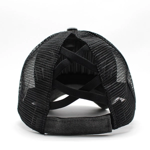 Detail of the elastic criss-cross high ponytail hole and breathable mesh on a black trucker cap