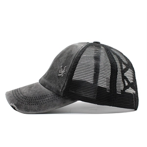 Detailed side view of washed cotton mesh cap with distressed brim and embroidery