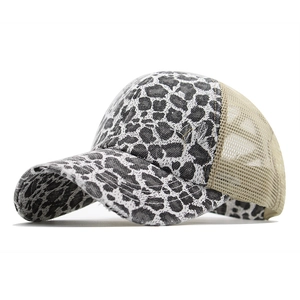 Detailed macro view of distressed leopard print brim and khaki mesh on trucker hat
