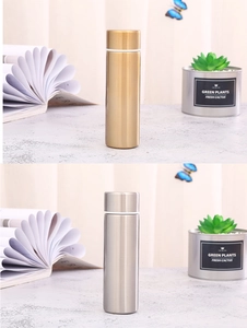 Detailed view of mini stainless steel vacuum flasks in gold and silver finishes