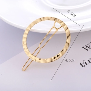 Minimalist golden round hair clip with hammered texture finish for women styling