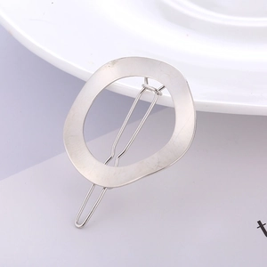 Detail of silver geometric hollow round hair clip with classic metal spring clasp