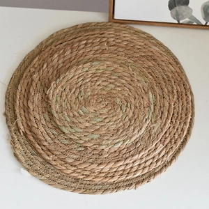 Macro detail of natural seagrass woven coaster with spiral pattern and reinforced edges