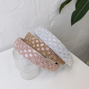 Macro shot of three crystal beaded padded headbands in pink, champagne and white