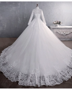Detailed back view of white lace long sleeve wedding dress with cathedral train