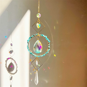 Close-up of crystal suncatcher casting rainbow light reflections on a warm wall