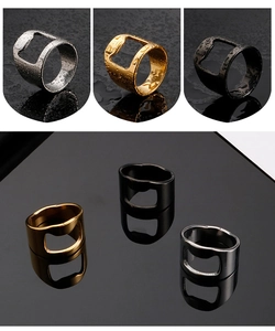 Detail of silver, gold and black stainless steel bottle opener rings with water droplets