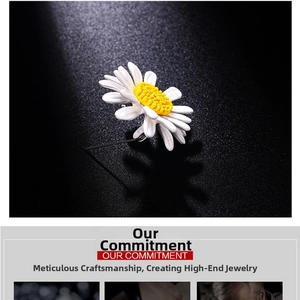 Detail of daisy brooch with white enamel petals and yellow core on black background
