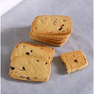 Golden cranberry cookies on double-sided baking paper for oven and pastry use