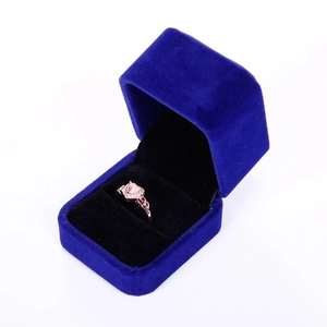 Top view of a pink heart gemstone ring inside a navy blue velvet jewelry box