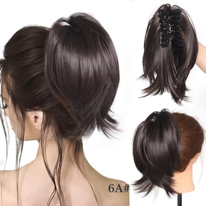 Macro view of short wavy synthetic hair bun extension with strong claw clip in dark brown