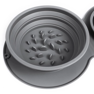 Grey foldable silicone slow feeder pet bowl with maze design on a white background