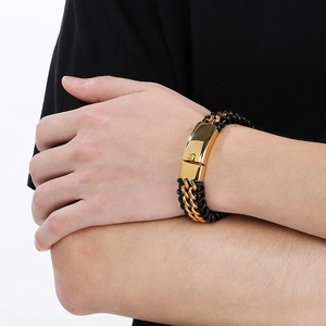 Close-up of black braided leather bracelet with gold-tone polished steel magnetic clasp