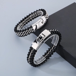 Close-up of punk style braided leather bracelets with polished stainless steel chain links