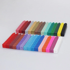 Macro shot of assorted colorful sealing wax sticks with embossed patterns on white background
