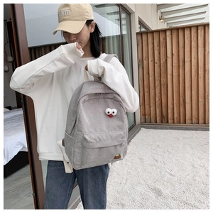 Light gray corduroy backpack featuring large cartoon eyes and cute embroidery for students