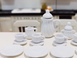 Macro detail of 15-piece white miniature ceramic tea set for 1:12 dollhouse decor