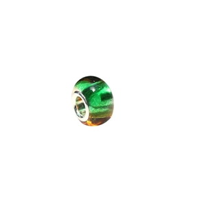 Macro shot of green and amber resin large hole charm bead with polished silver metal core