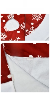 Detail of red Christmas tree skirt with white snowflakes and velcro closure mechanism