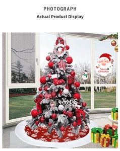 Close-up of red Christmas tree skirt with white snowflake patterns and festive ornaments