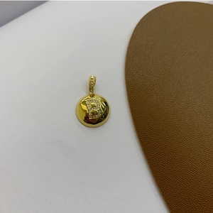 Macro shot of 18K gold-plated round pendant with sparkling zircon initial B detail