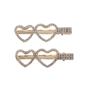Close-up of gold-plated hair clips with hollow heart shapes and sparkling rhinestones